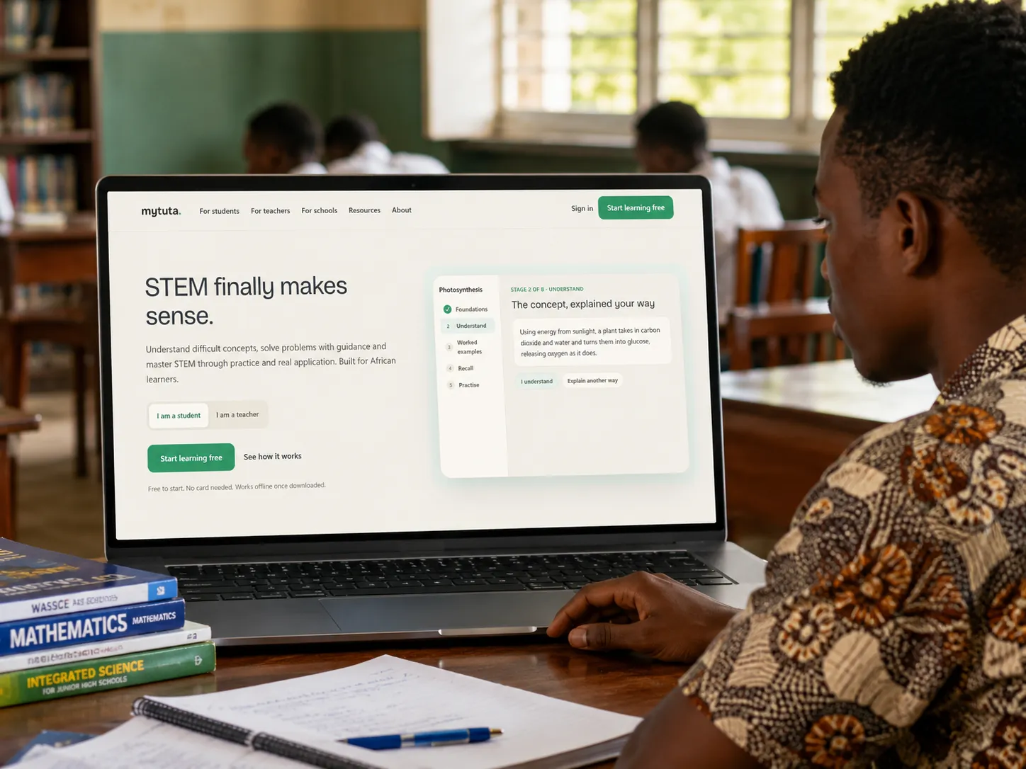 A student working through a Mytuta STEM lesson on a laptop in a school library, with WASSCE textbooks on the desk